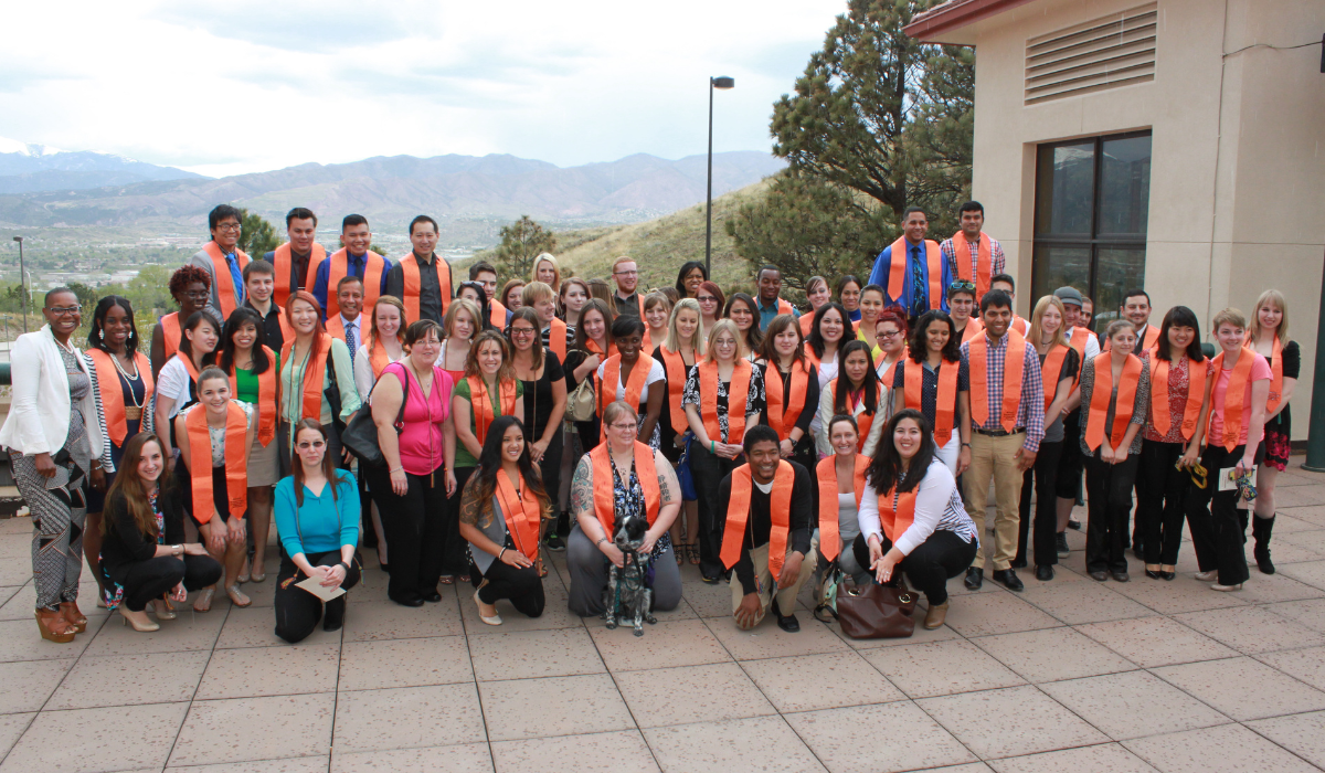 Photo of a group of MOSAIC graduates wearing orange stoles