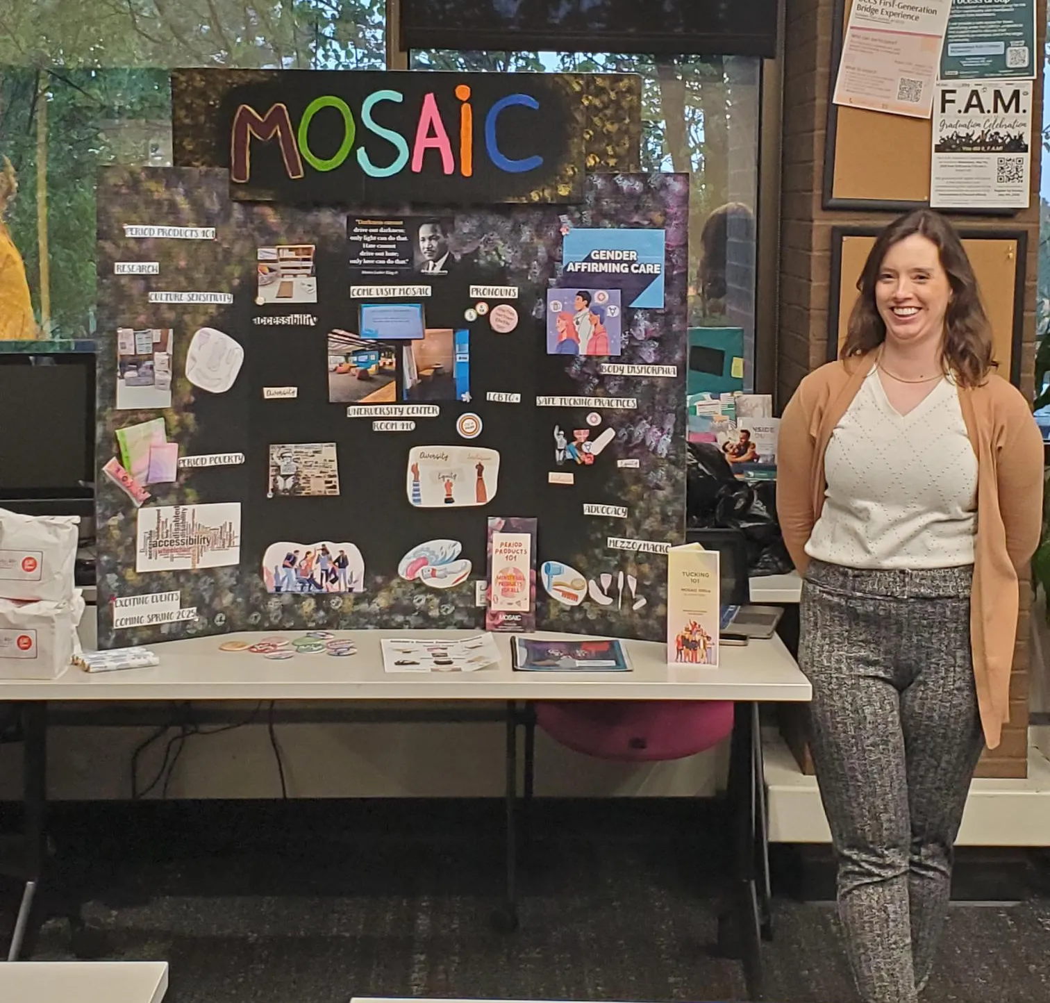 Image of student posing with their poster board highlighting their practicum project on gender expansive resources